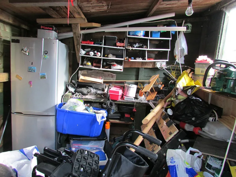 Cluttered garage before property cleanout service in West Central Florida